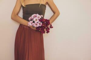 Woman holding beautiful bouquet of flowers.Focus on flowers. photo