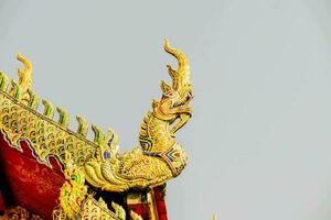 golden dragon on the roof of a temple photo