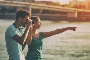 Young happy couple photographing together. photo