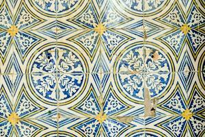 a close up of a blue and white tile wall photo