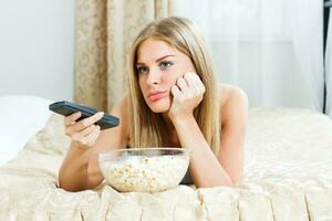 Sad woman watching tv photo