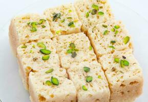 Indian Traditional Famous Sweet Food Mysore Pak or Mysoor Pak on White Background photo