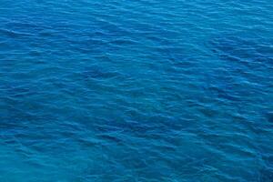 the blue sea is seen from above photo