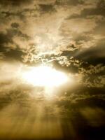 sunbeams shining through clouds in the sky photo