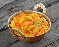 Indian Cuisine Spicy Fried Aloo on Wooden Table photo