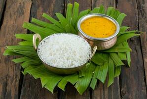 Indian Traditional Cuisine Dal Fry or Rice Also Know as Dal Chawal on Wooden Background photo