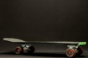 a black skateboard and a black background photo