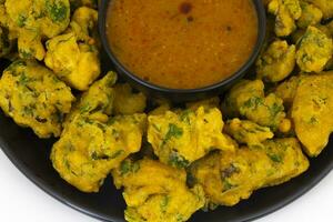 Indian Favourite Street Fried Food Pakora Served with Chutney photo