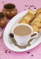 Indian Popular Drink Masala Chai or Masala Tea on Pink Background photo