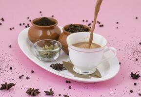 Indian Popular Drink Masala Chai or Masala Tea on Pink Background photo