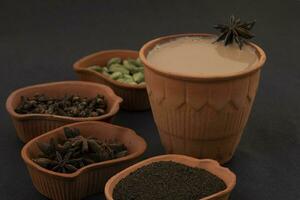 Indian Popular Drink Masala Chai or Masala on Black Background photo