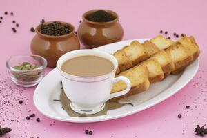 Indian Popular Drink Masala Chai or Masala Tea on Pink Background photo