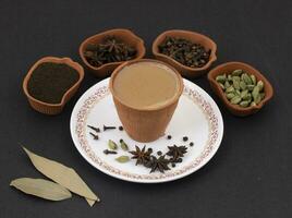 Indian Popular Drink Masala Chai or Masala on Black Background photo