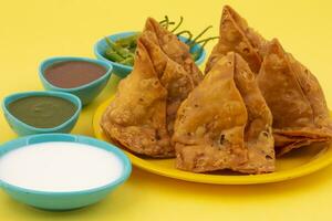 Indian Street Food Samosa or Samosas is a Crispy And Spicy Triangle Shape Snack photo