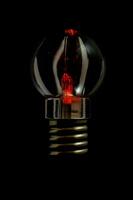 a red light bulb in the dark photo
