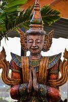a statue of a thai god photo
