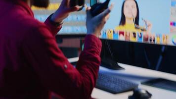Freelancer editing images lighting and color balance, working in home studio while enjoying music. Photographer using headphones to listen favorite songs while using retouching software video