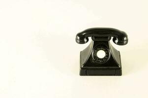 a black telephone on a white background photo