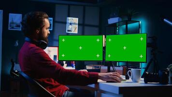 Photographer using photo editing software on mockup multi monitors setup to improve images quality. Photo editor utilizing specialized photographs retouching application on isolated screen display