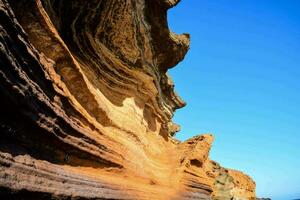 the rock formations on the beach are very colorful photo