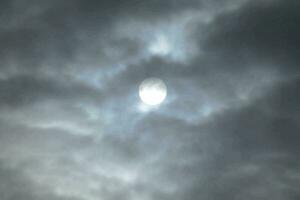 the moon in the cloudy sky photo