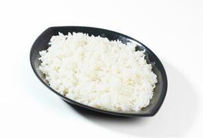 bowl of boiled rice on white background photo