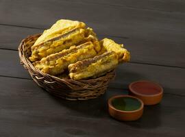 Indian Fried Snack Bread Pakora or Bread Bhaji Served with Tomato Ketchup, Green Chutney it is Made From Bread Slices photo