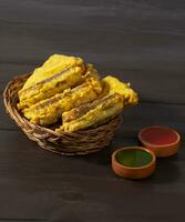 Indian Fried Snack Bread Pakora or Bread Bhaji Served with Tomato Ketchup, Green Chutney it is Made From Bread Slices photo