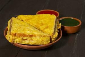 Indian Fried Snack Bread Pakora or Bread Bhaji Served with Tomato Ketchup, Green Chutney it is Made From Bread Slices photo