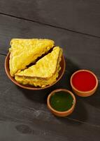 Indian Fried Snack Bread Pakora or Bread Bhaji Served with Tomato Ketchup, Green Chutney it is Made From Bread Slices photo