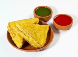 Indian Fried Snack Bread Pakora or Bread Bhaji Served with Tomato Ketchup, Green Chutney it is Made From Bread Slices photo
