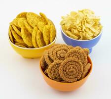 Indian Traditional Snack Chakli With Masala Khari Papdi or Besan Papdi on White Background photo