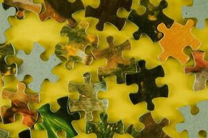 puzzle pieces on a yellow table photo