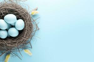 AI generated Easter eggs in a nest on a blue background photo