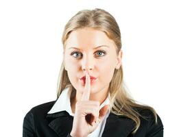 Businesswoman with finger on her lips photo