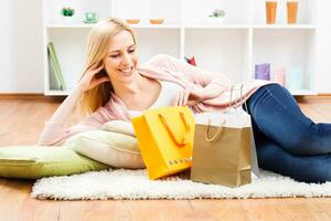 Woman laying on the floor with shopping bags photo