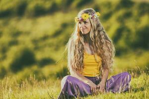 Beautiful blonde woman with wreath in her hair enjoys  in nature. photo