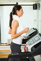 Fitness woman exercising on treadmill at the gym. photo