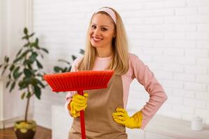 Beautiful housewife enjoys cleaning her home. photo
