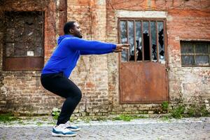 Sporty man enjoys  exercising outdoor. photo