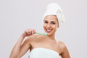 Beautiful woman brushing her teeth photo