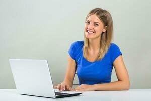 Portrait of beautiful young woman using laptop. photo