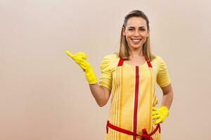 Portrait of happy housewife pointing photo