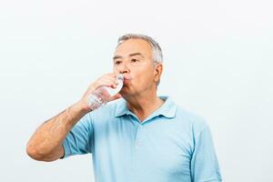 Senior man drinking water photo