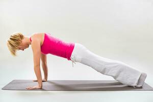 Woman exercising yoga indoor photo