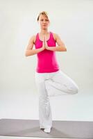 Woman exercising yoga indoor photo