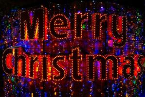 Merry Christmas word neon sign. Christmas lights in night city. photo
