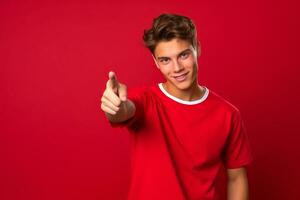 AI generated Confident Young Man Pointing Forward on Red Background photo