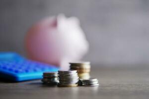 Selective focus image of coins, calculator and piggy bank with copy space for text. Financial concept. photo
