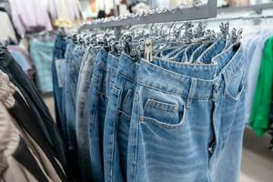 Blue Jeans Hanging on a Hanger in a Stylish Fashion Store Display photo